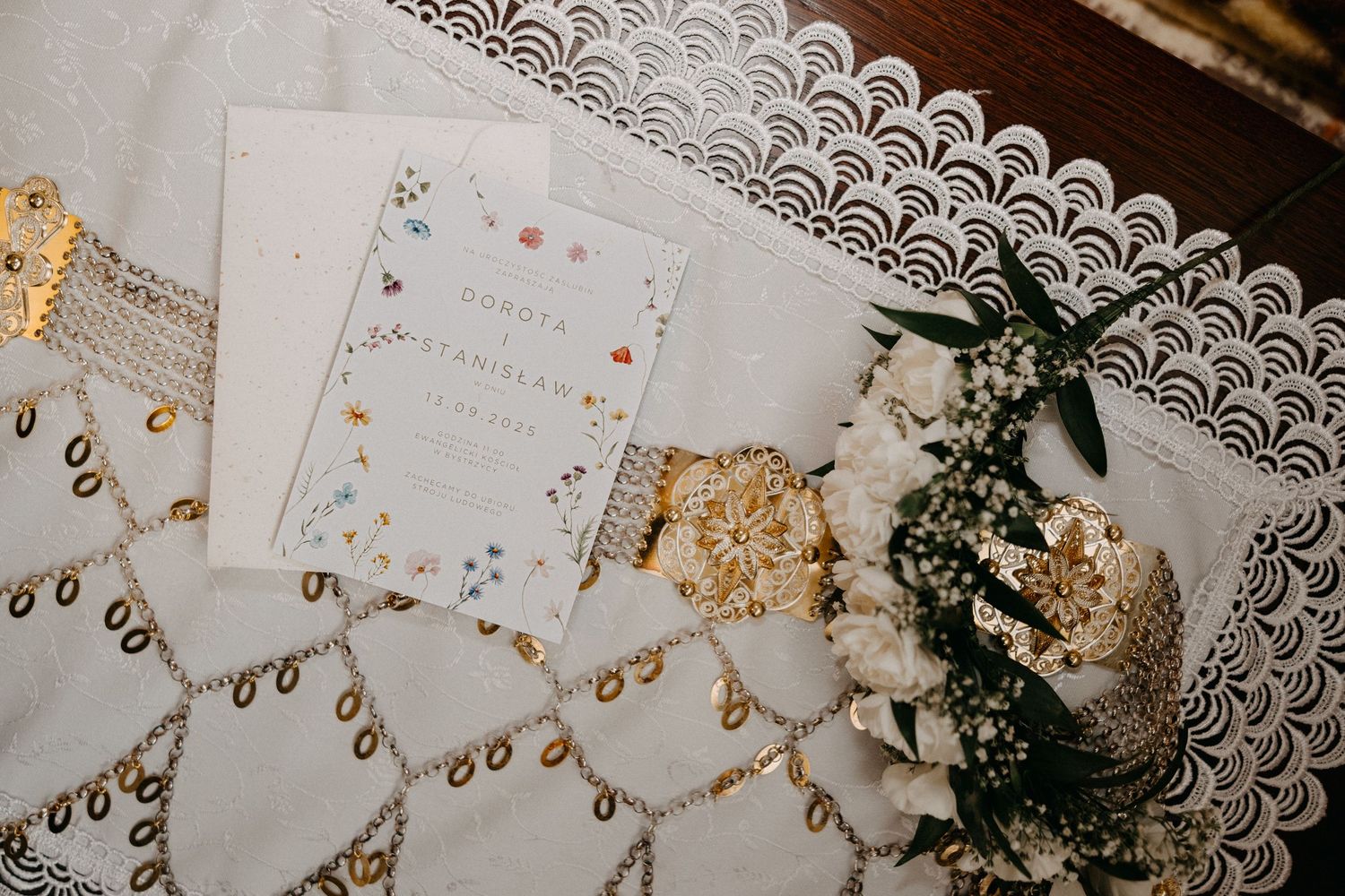 White lace doily with scalloped edges displayed on dark wooden surface.