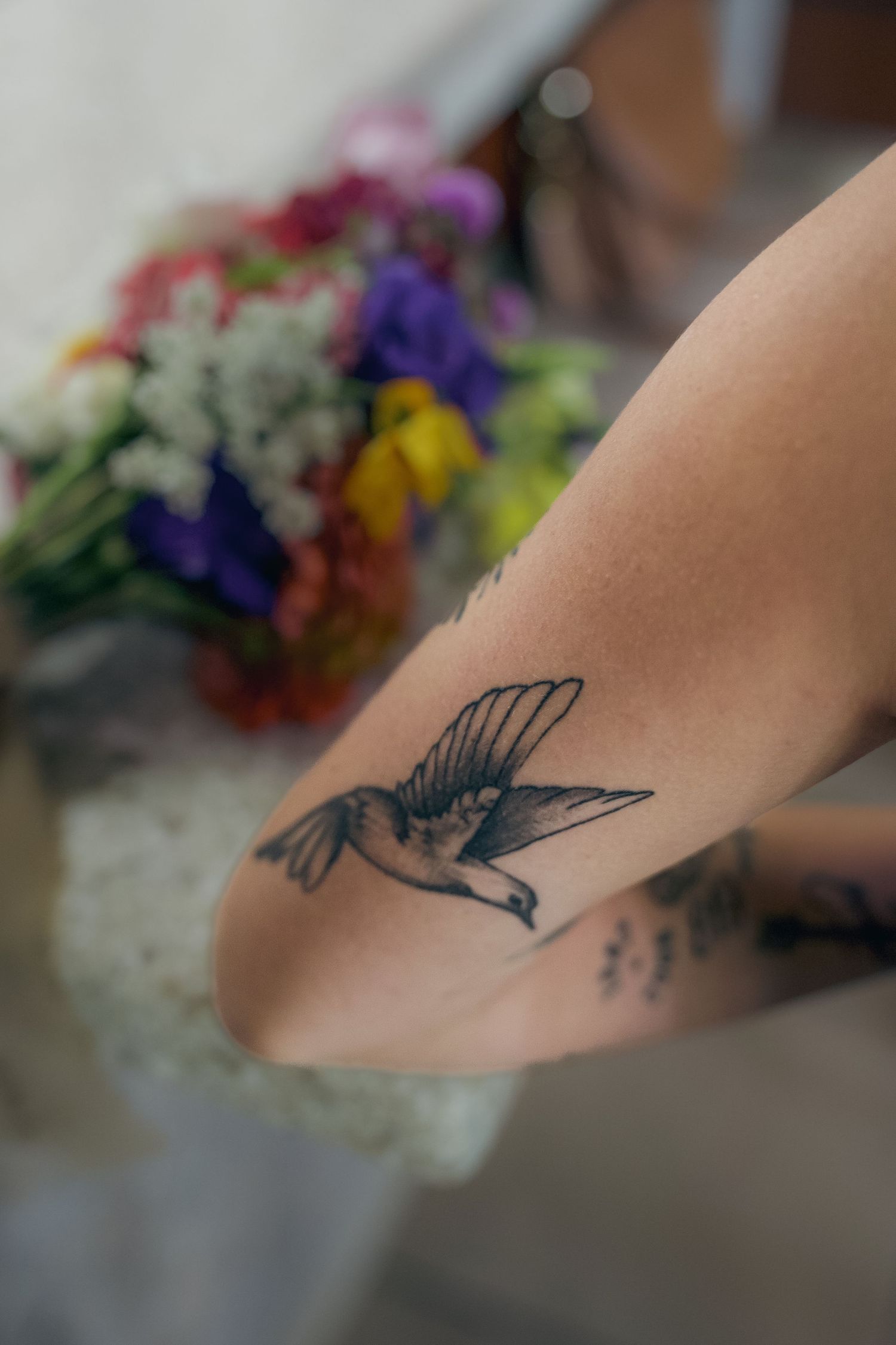 A black butterfly tattoo design shown in progressive stages across multiple photos of someone's arm.