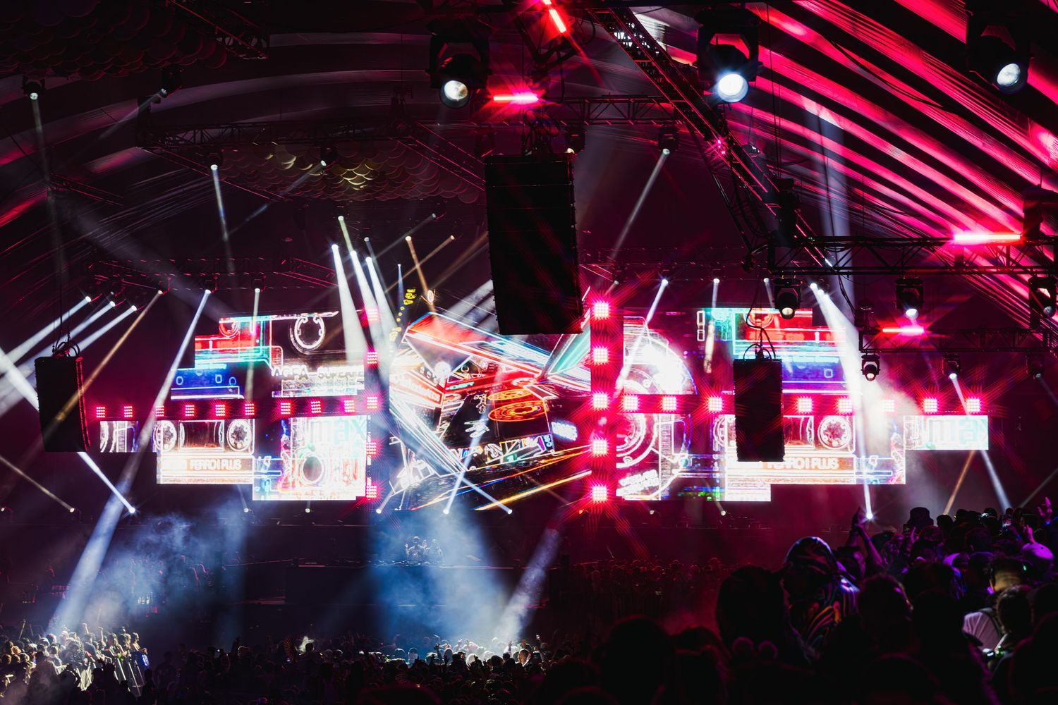 Concert stage illuminated with vibrant red and blue lights during a live performance with fog effects.