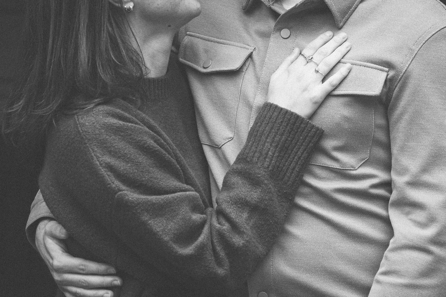 Intimate black and white portrait of couple embracing.