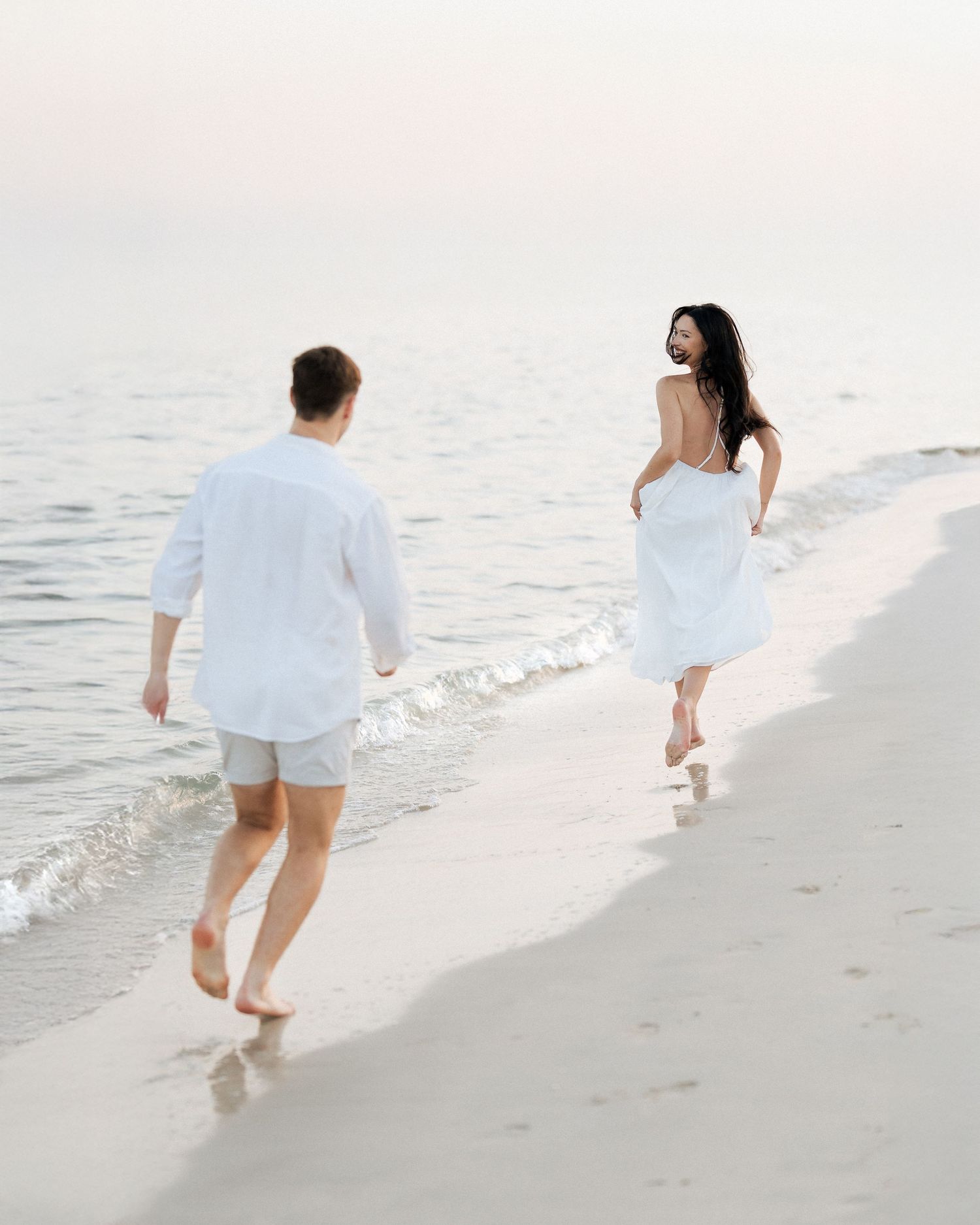Candid couple walking along the shoreline in Dubai