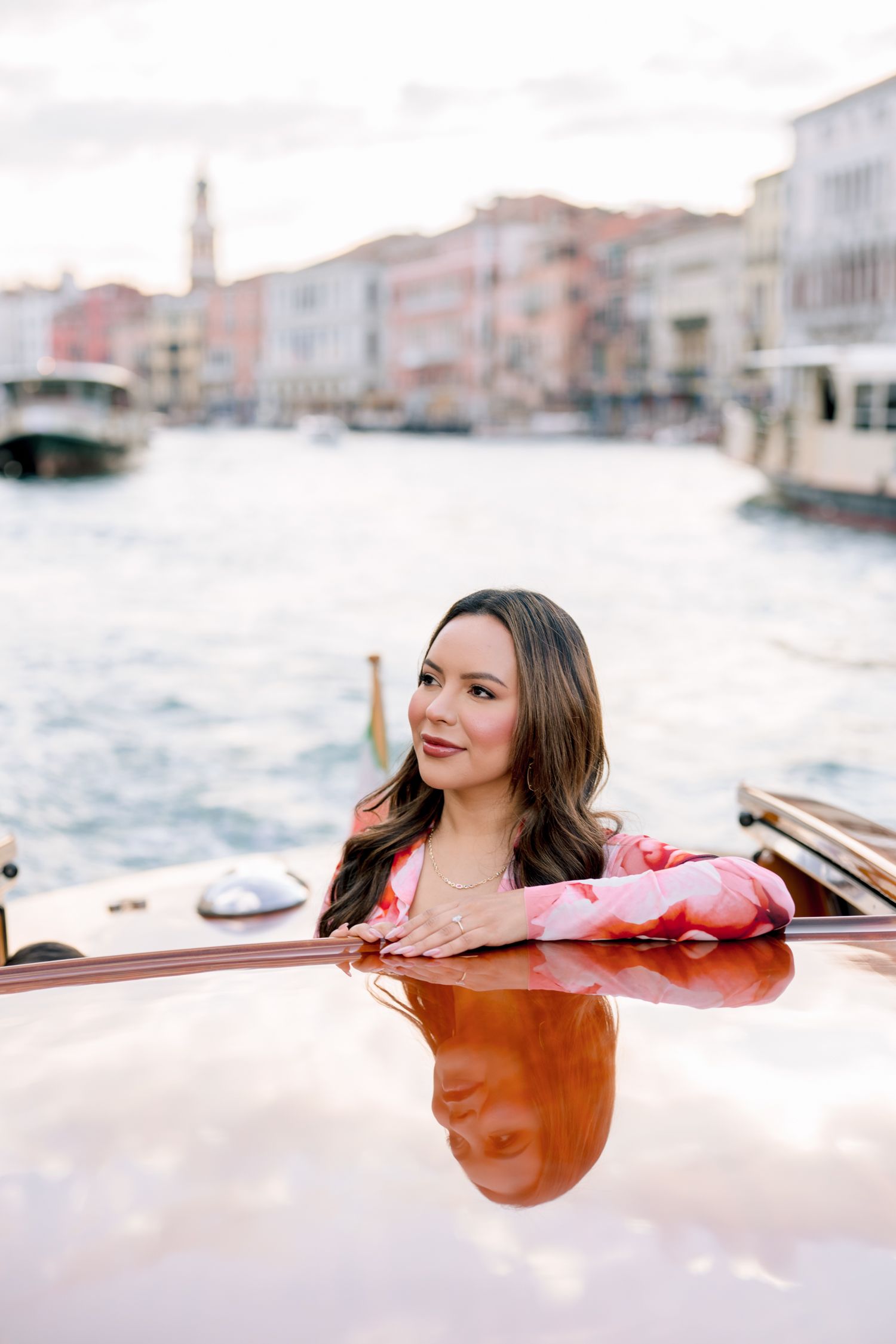 Romantic boat ride through Venice canals at sunset with warm golden light reflecting off the water.