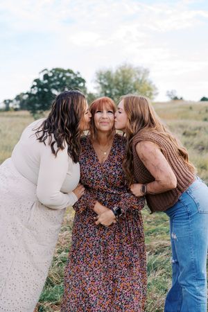 Family members sharing affectionate moments in an outdoor setting.