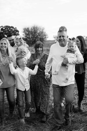 Black and white candid family photo showing joyful expressions.