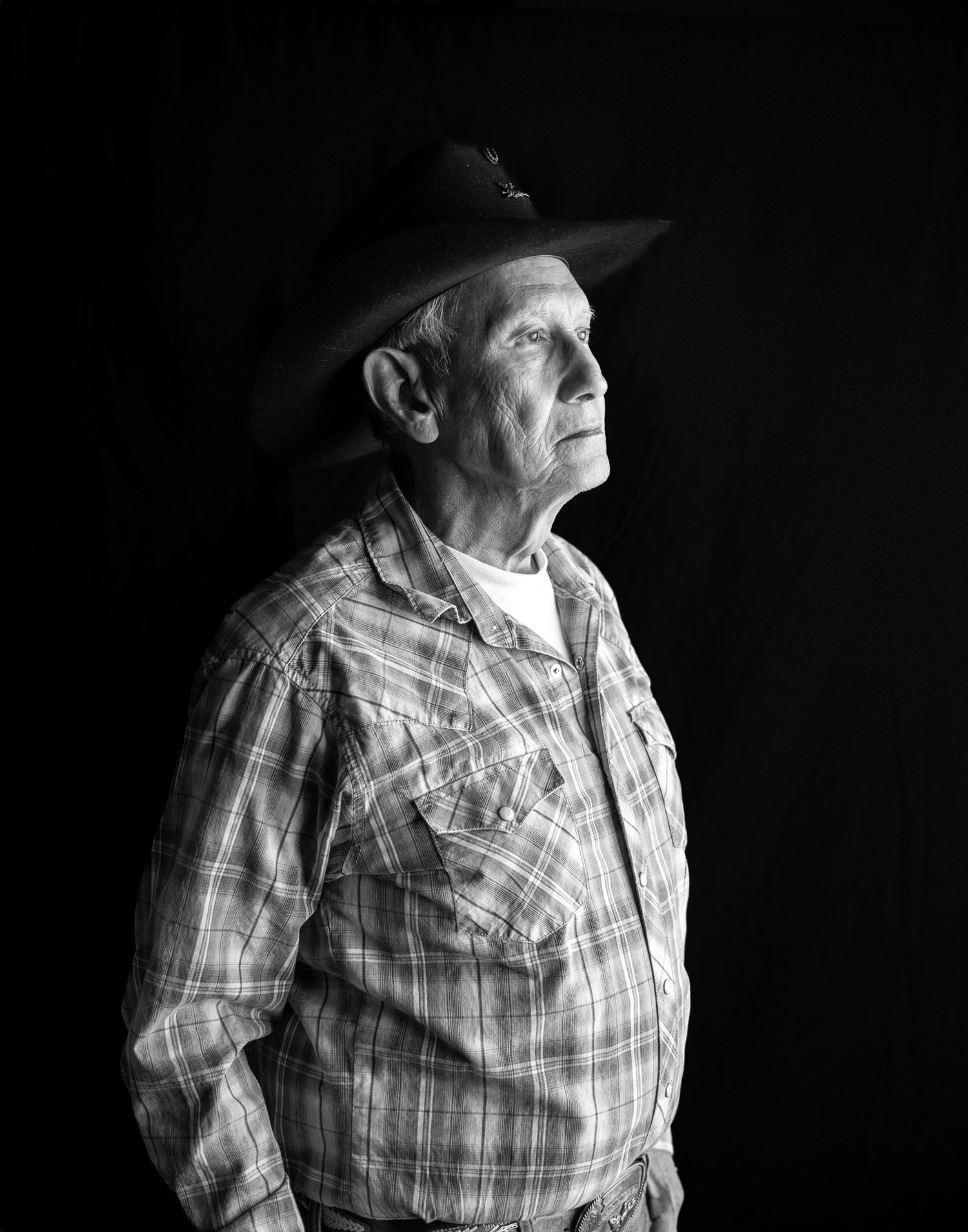 studio portrait, natural light, black and white, cowboy hat, elderly man, looking out window
