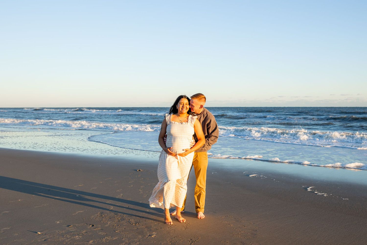 Crystal Coast maternity photography session featuring an expecting mom standing barefoot in the sand near Swansboro, NC at golden hour