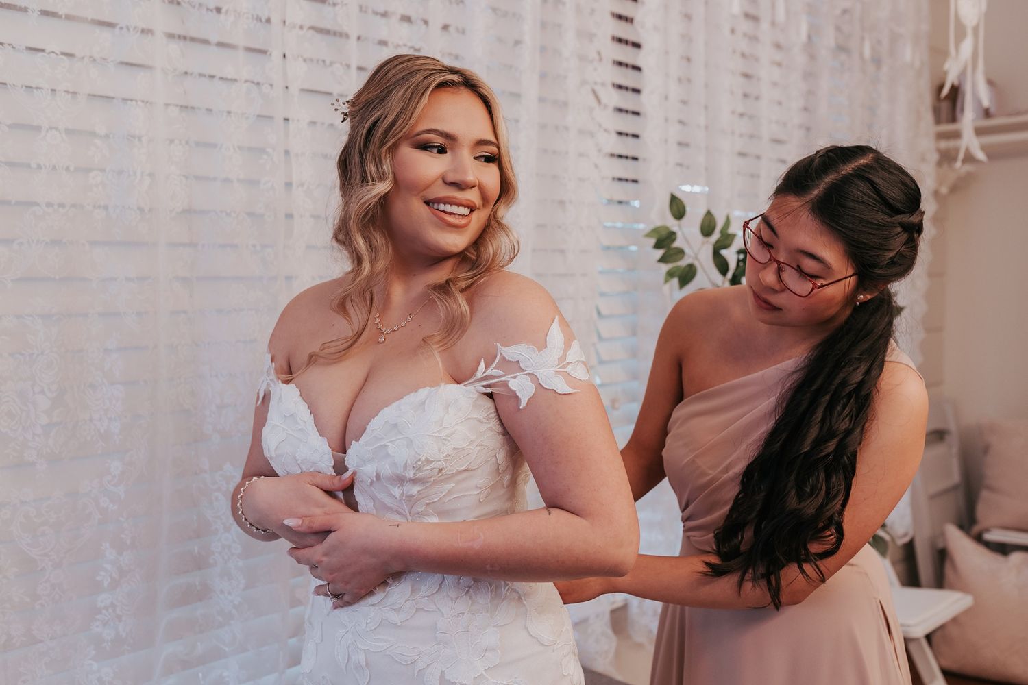 A bride and her bridesmaid share a joyful moment before the wedding ceremony at Singing Hills Golf Resort.