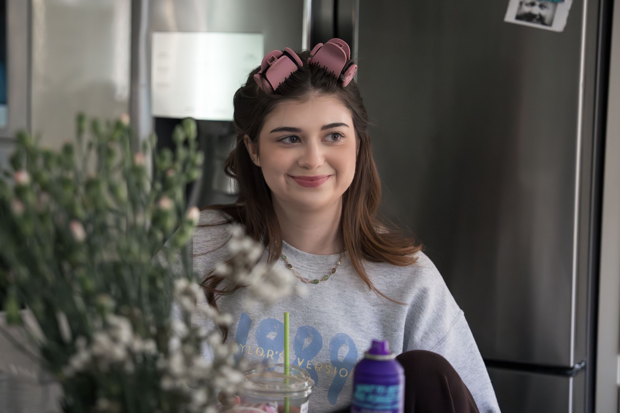 A series of photos shows someone in a white sweater posing with a cat ear headband and holiday decorations.