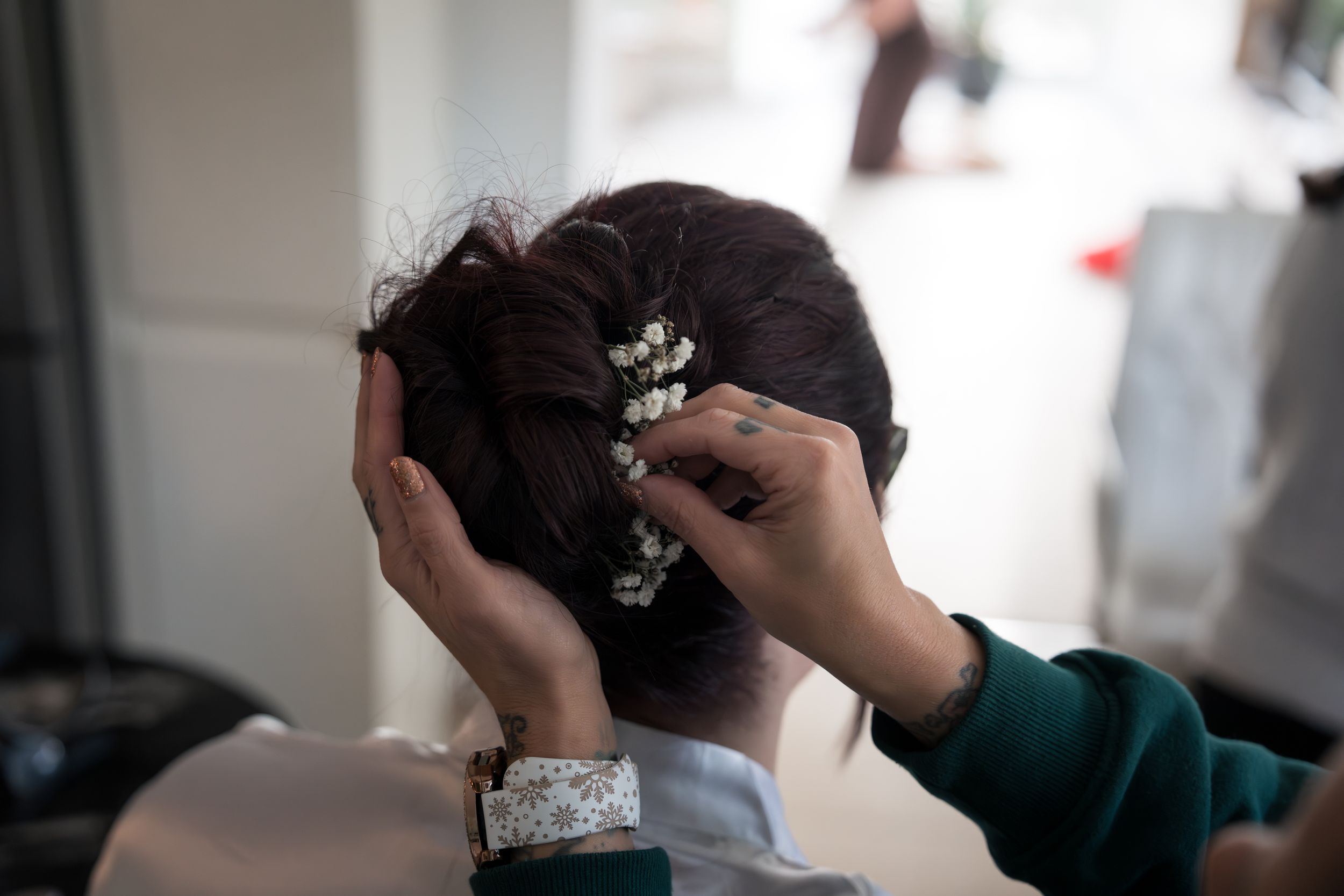 A series of photos showing hands styling and arranging hair with decorative accessories and pins.