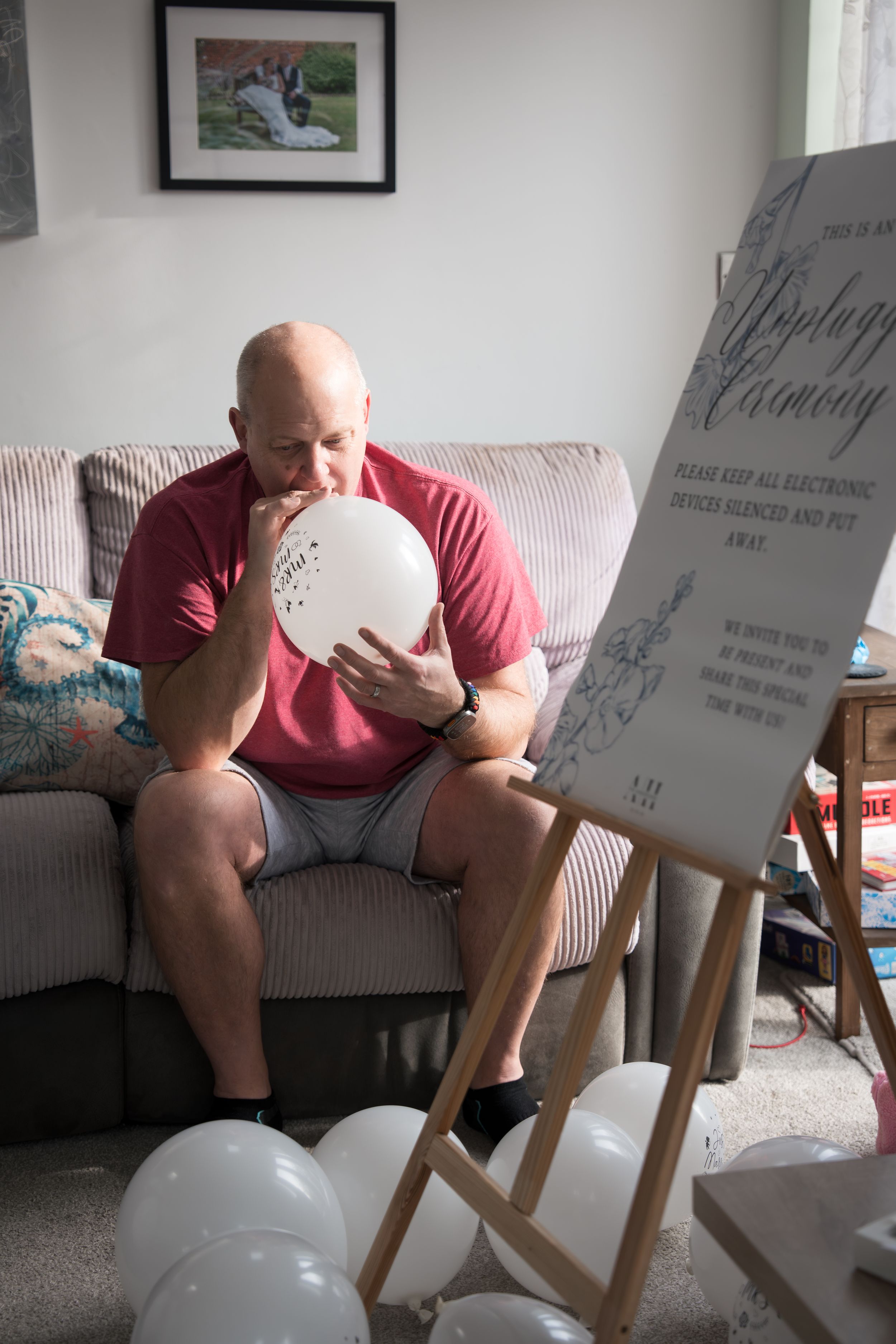 Someone in a red shirt sits on a striped couch looking at a balloon in a sequence of progressive images.