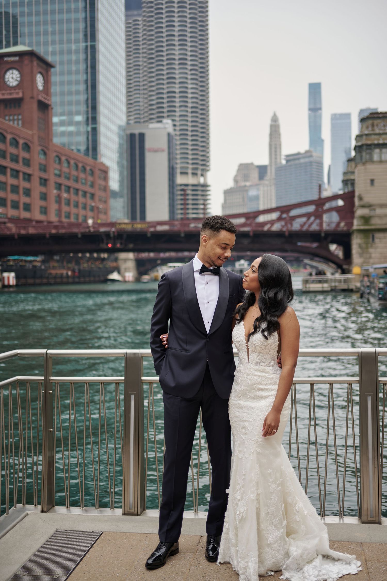 An outdoor autumn wedding ceremony on a wooden deck with golden trees providing a scenic backdrop for the celebration.