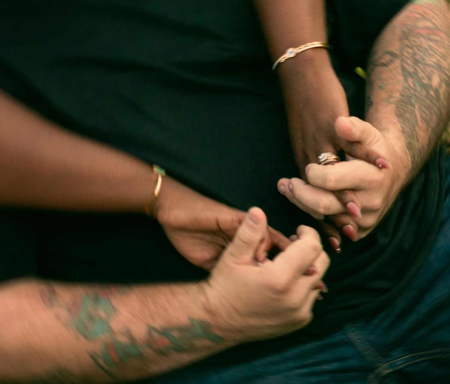 Close-up sequence showing hands performing a traditional stick and poke tattoo process with ink and needle.