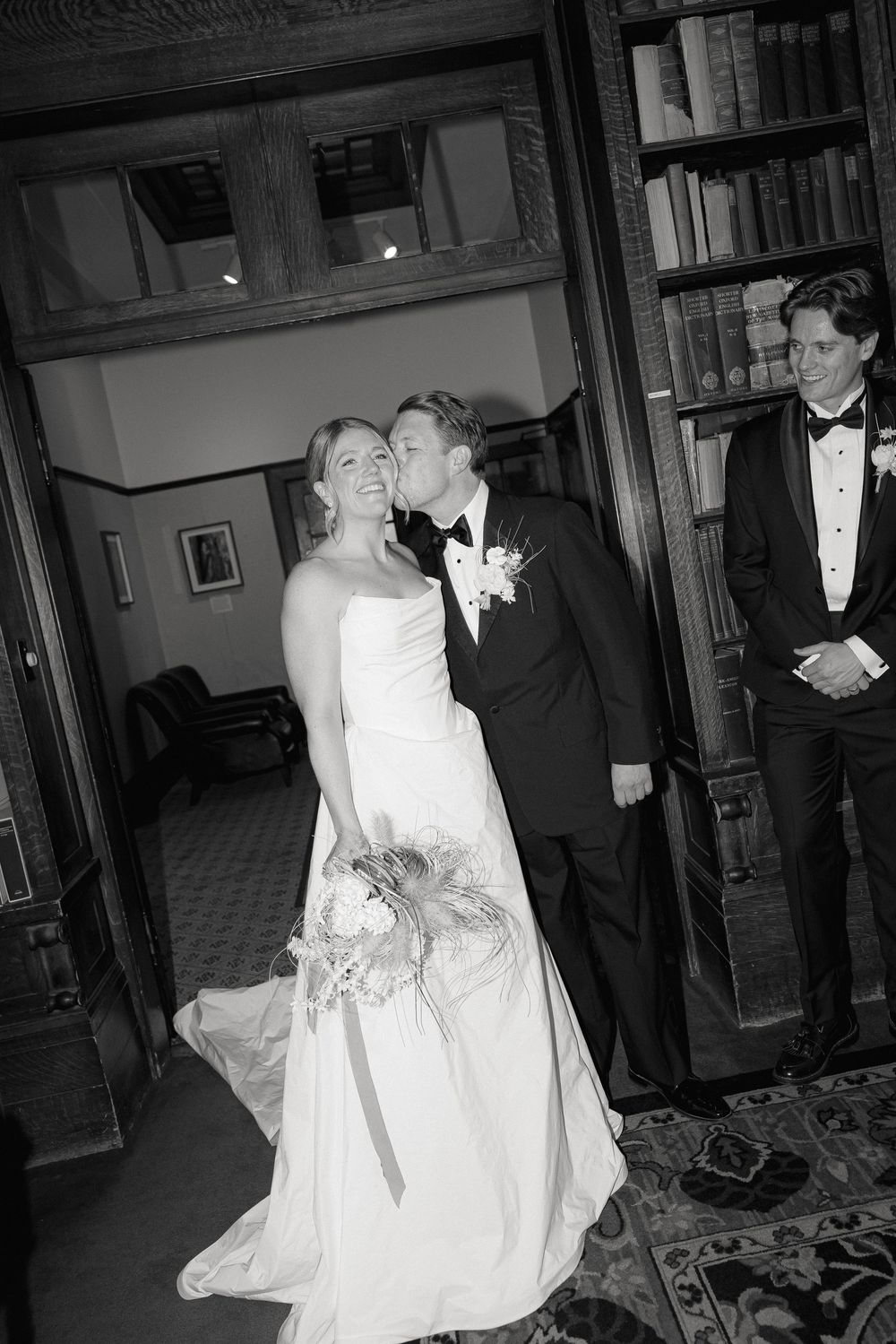 Black and white photos show intimate wedding moments in an indoor venue with elegant decor.