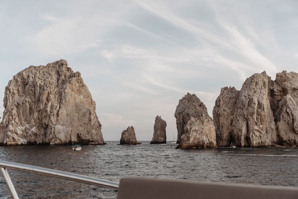 Scenic view of rugged rock formations rising from the ocean at Land's End in Cabo San Lucas, Mexico.