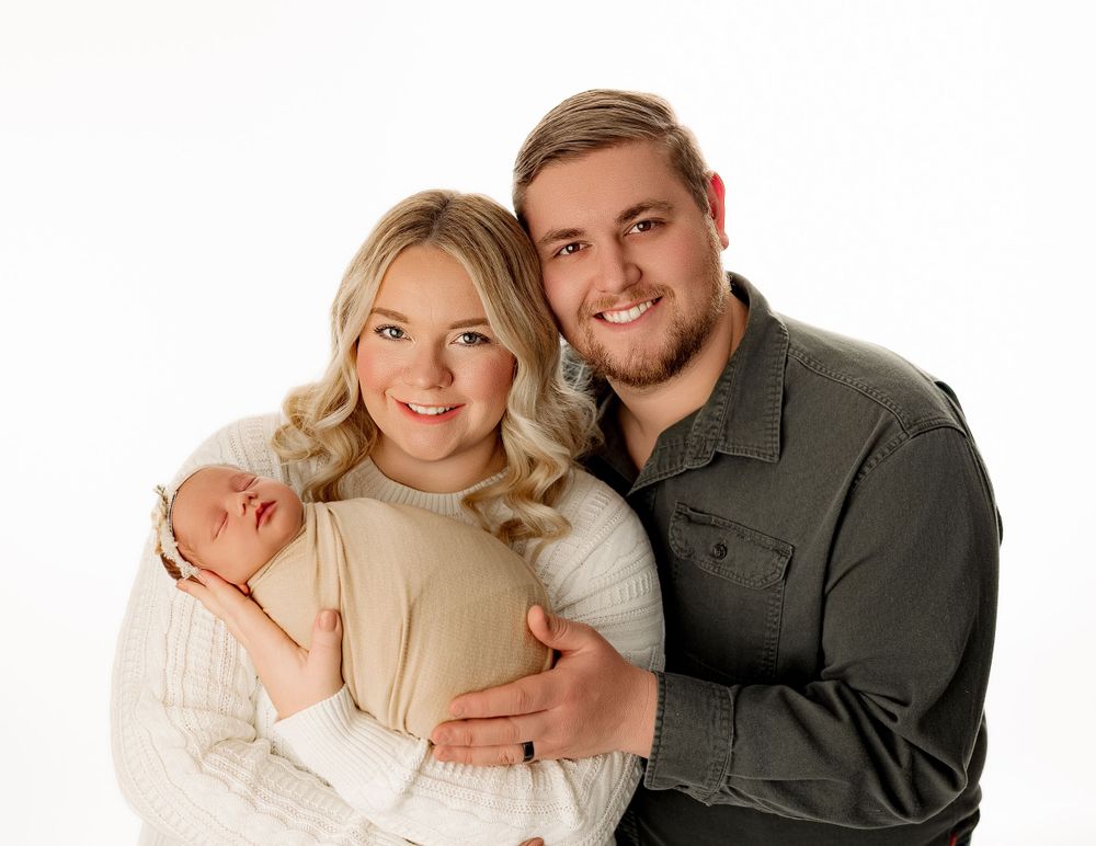 Family Love with Baby Emersyn | Portsmouth, OH Photography – A heartwarming moment of Emersyn with her loving parents, captured by Bailey’s