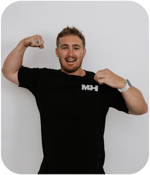 Person in black MH branded t-shirt flexing muscles against white background.