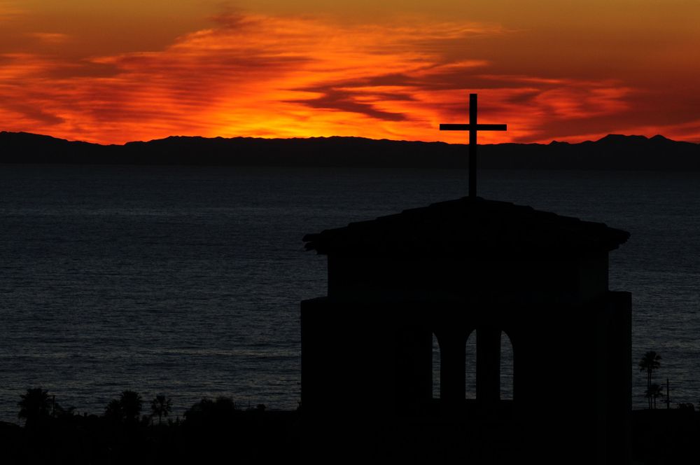 Silhouette of a mission style church in Laguna Niguel, CA overlooking the Pacific Ocean