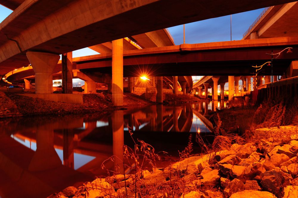 Boston, MA highways crisscrossing a small river lit by sulfur dioxide lights