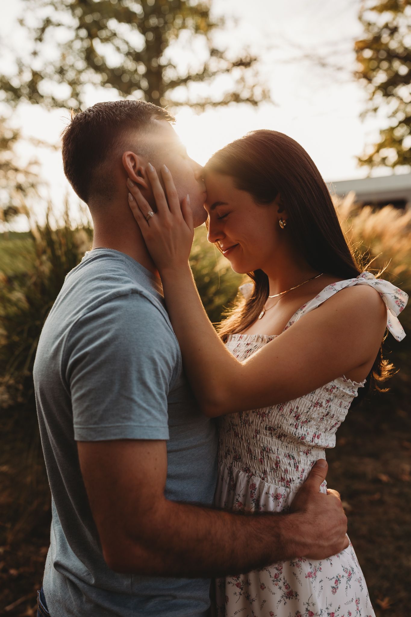 couple golden hour forehead kiss warm embrace