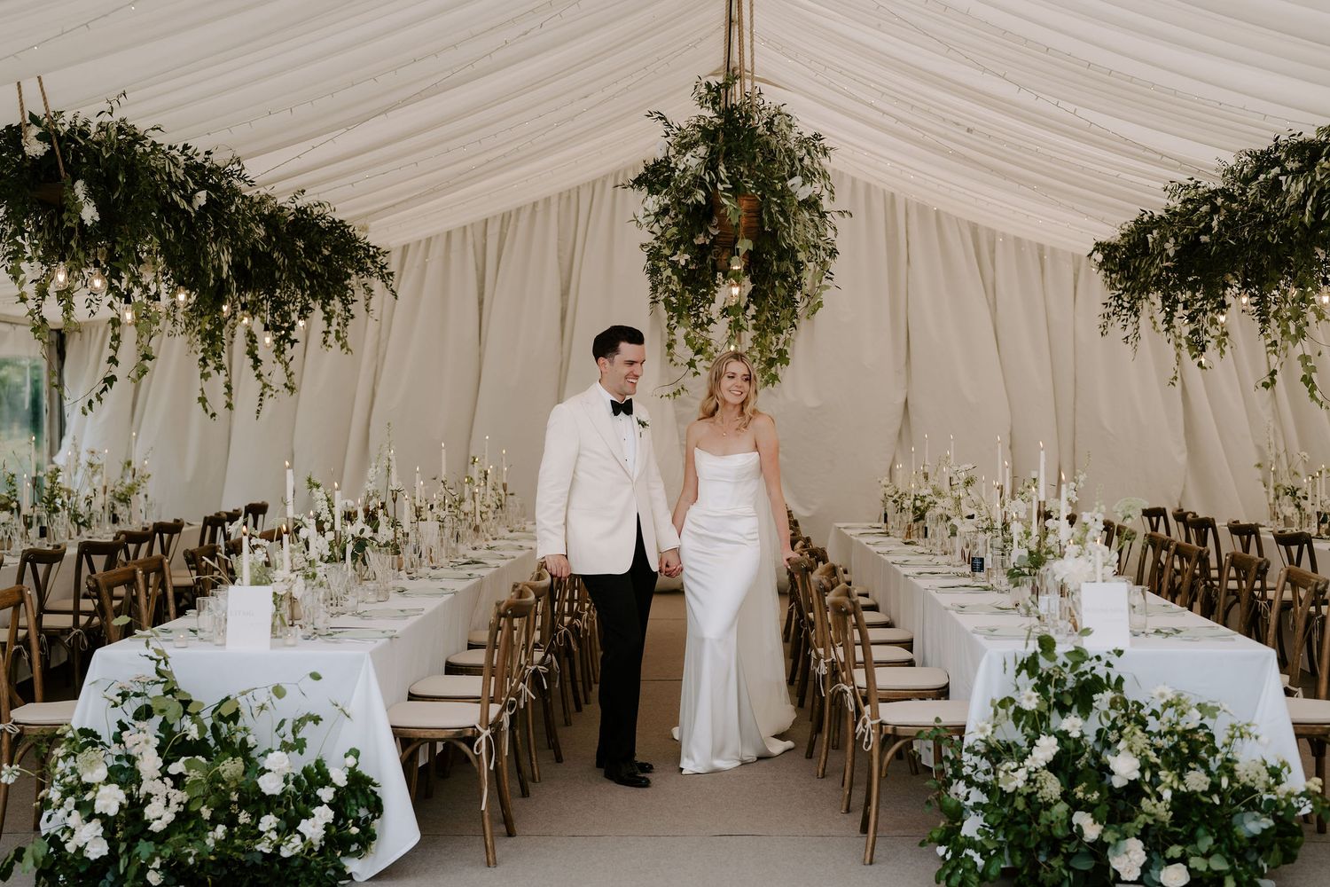bride and groom in wedding breakfast room, admiring the styling and decor, surrounded by flowers at hamswell house in bath