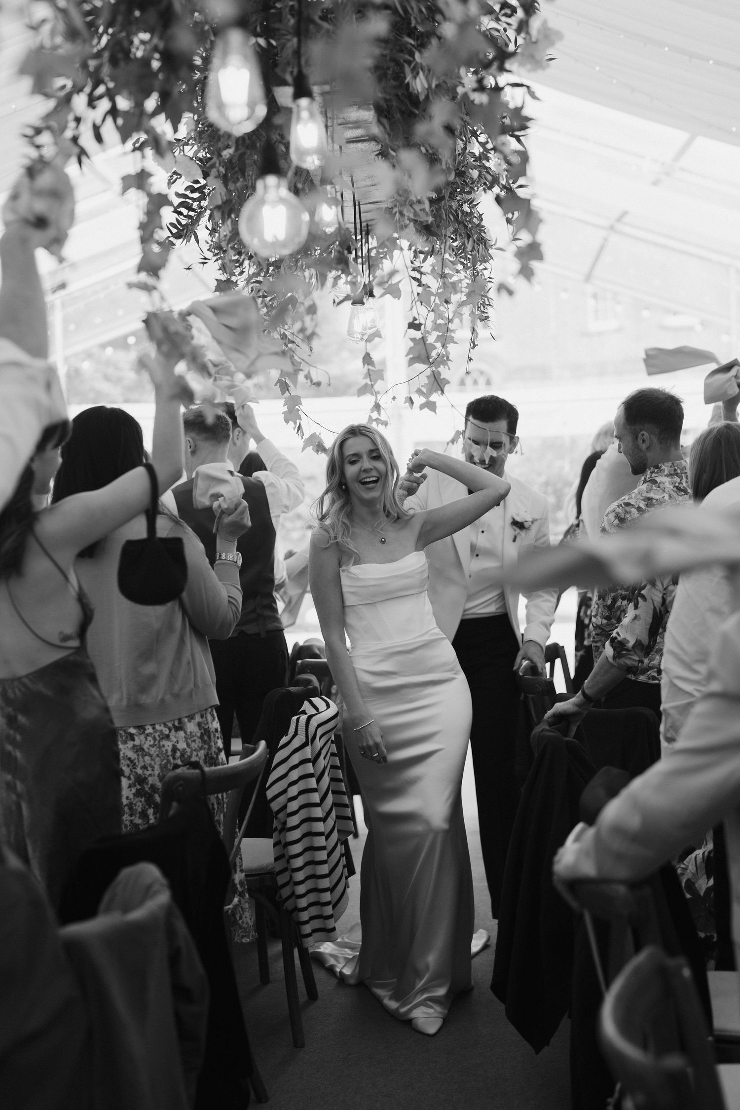 bride and groom getting cheered as they enter their wedding breakfast at hamswell house wedding in bath