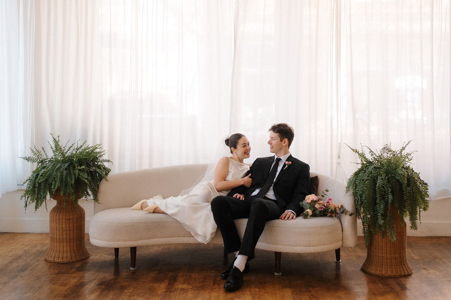 Sydney and Easton pose on a couch at the 201 Venue in Downtown Seattle's Pioneer Square