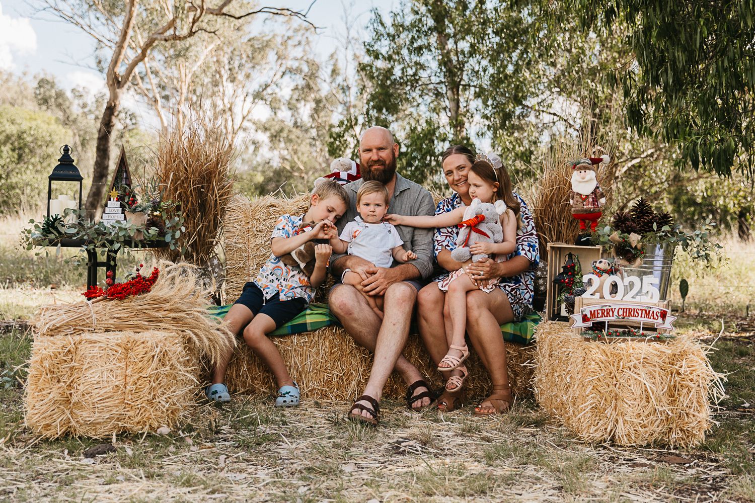 Family at a Christmas mini photo shoot in a rustic country setting.