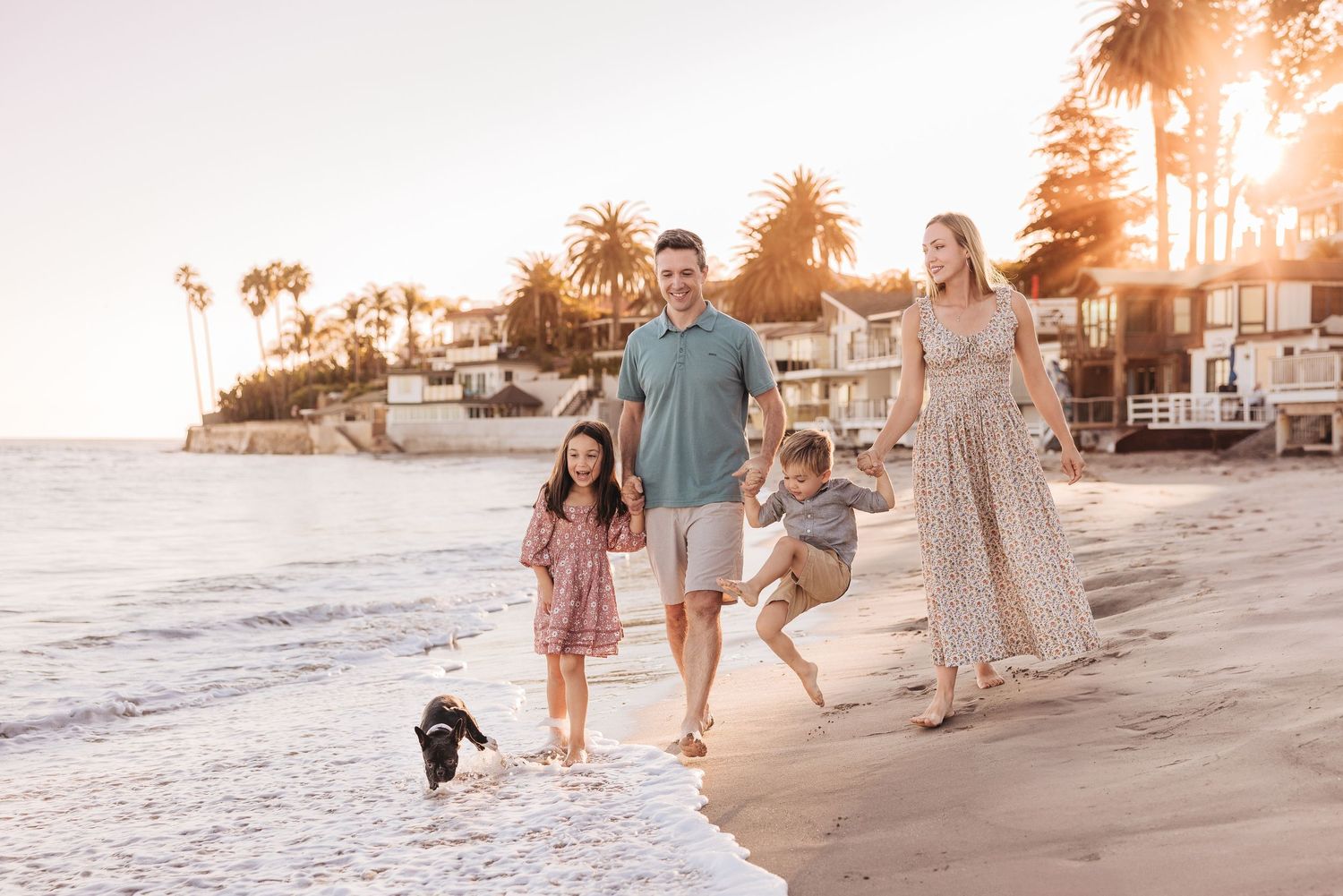 Family walking on beach at golden hour. how to dress family for professional photos at the beach in Santa Barbara, CA