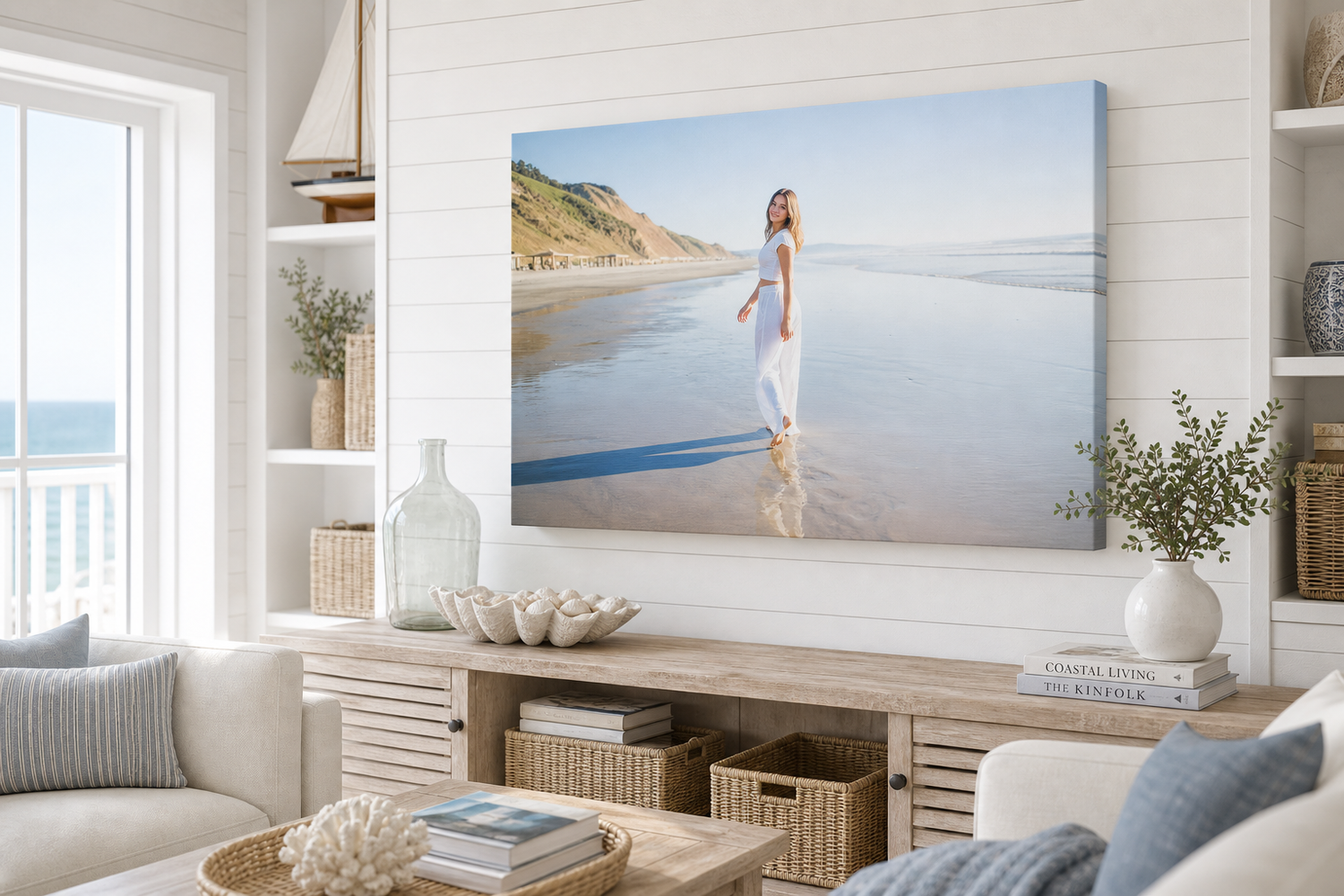 Canvas wall art of a woman in white dress on a sunny beach, displayed in a bright coastal living room.