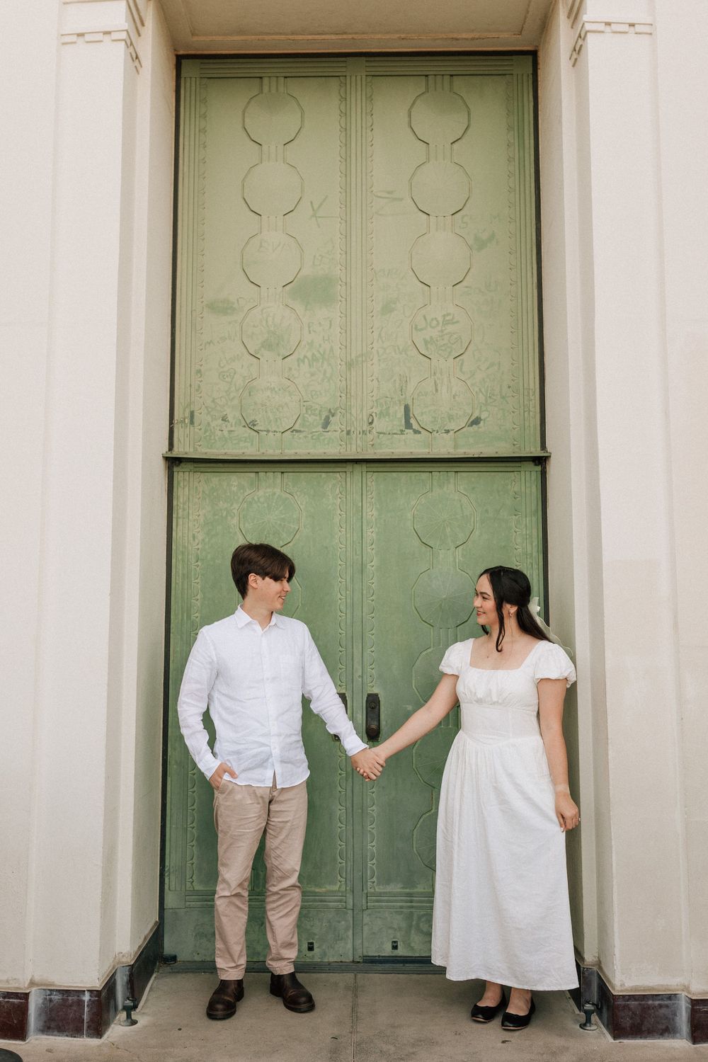 Anti-bride engagement portraits overlooking Los Angeles at Griffith Observatory, blending digital and real film for Charlotte NC