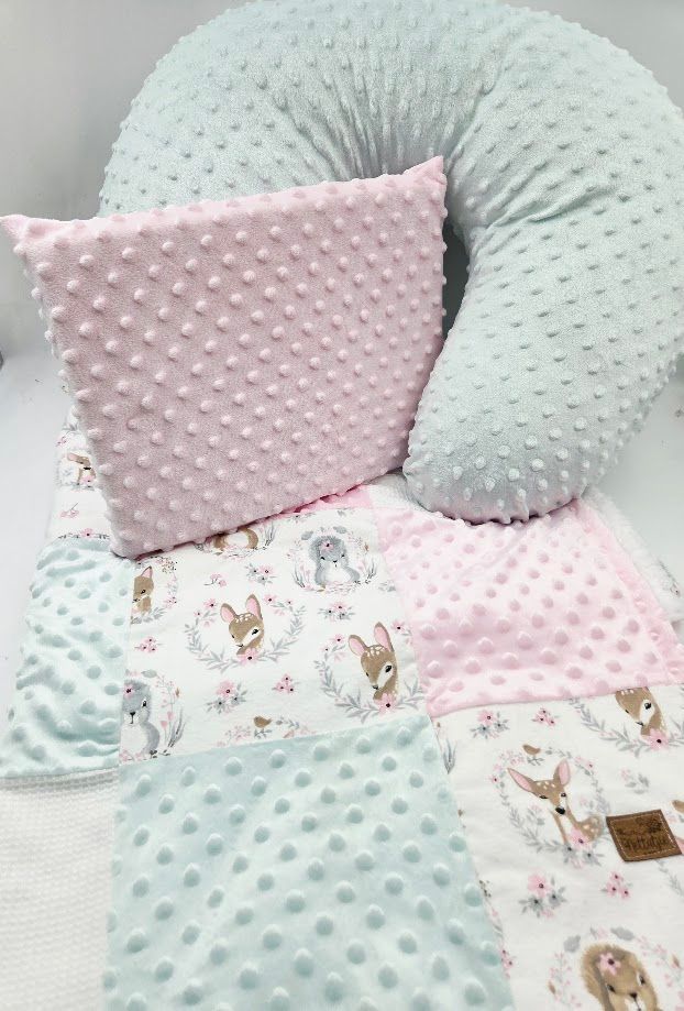 Pastel pink and mint baby set with dimple pillow, nursing pillow, and woodland animal patchwork blanket.