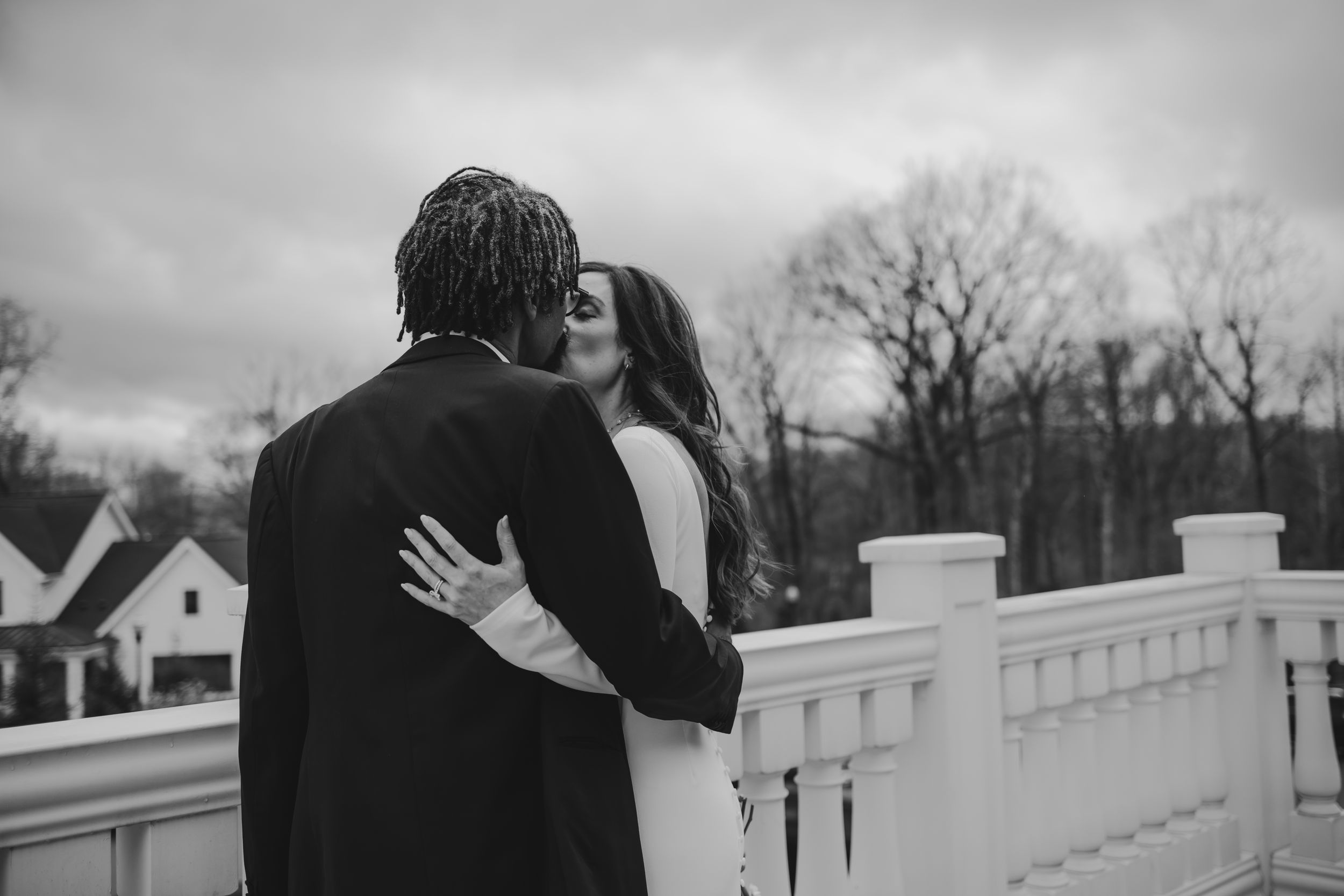 Bride and groom, wedding portrait kissing on a windy day at Holliday Farms in Zionsville, Indiana