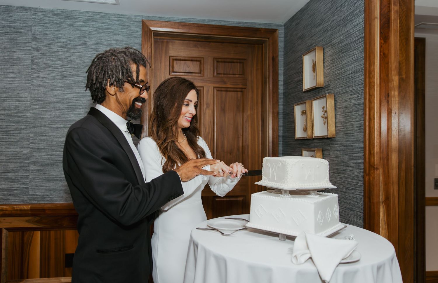 Bride and groom cutting their cake at their wedding reception at Holliday Farms in Zionsville, Indiana
