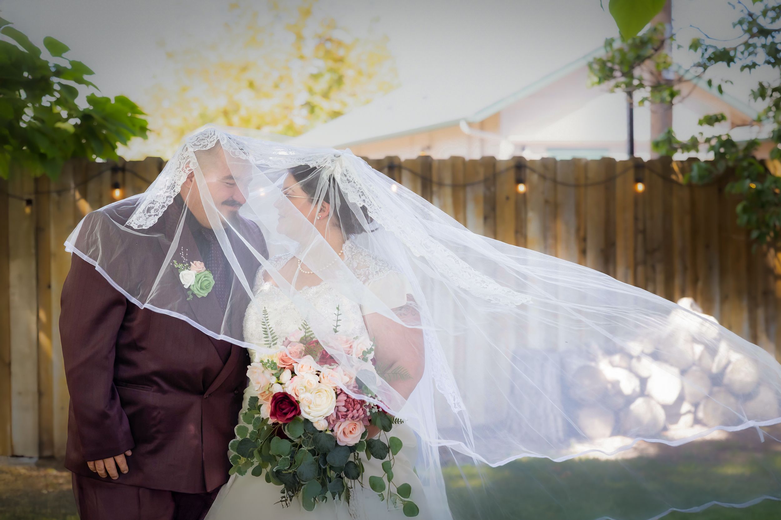 Hidden Gem wedding Meridian Idaho Bride and groom with veil over them