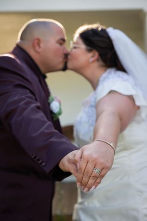 Hidden Gem wedding Meridian Idaho bride and groom kiss focus on rings