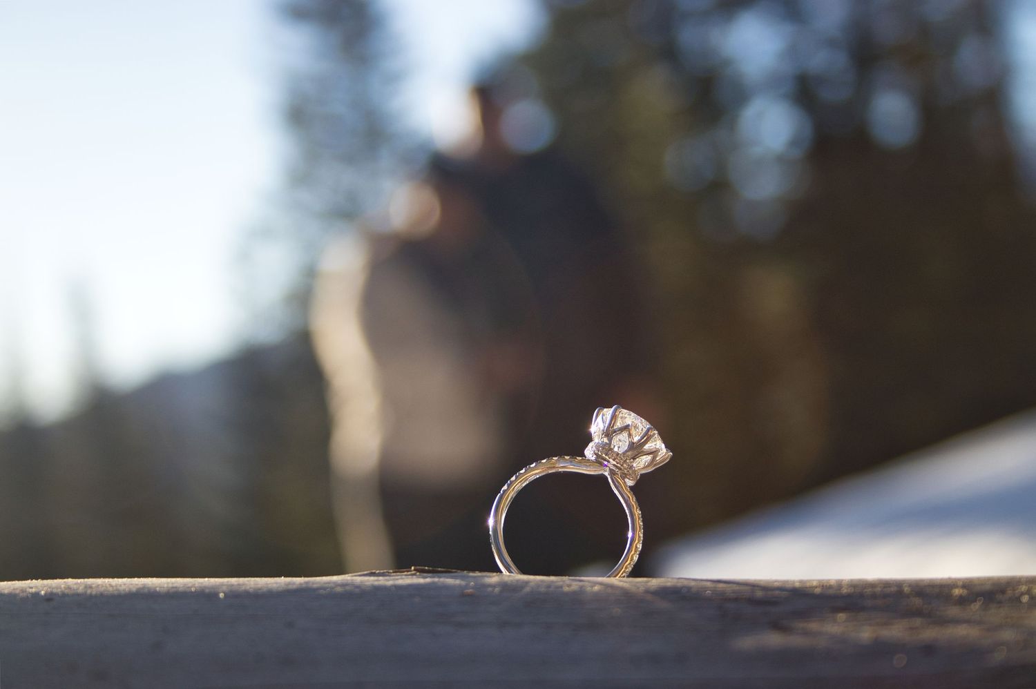 Profile shot of her engagement ring with both of them in the background. Pixcapades | The Rocky Mountain Proposal Photographer