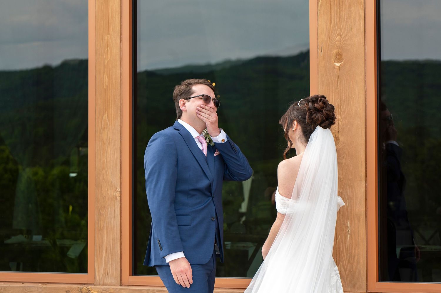 Bride and groom share a romantic moment under a flowing veil on their wedding day outdoors. vinewood stables wedding photos