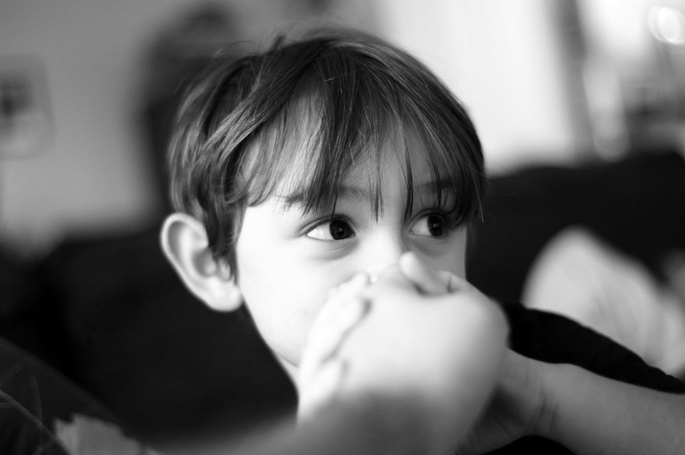 A series of black and white portraits showing different facial expressions and angles in an artistic style.