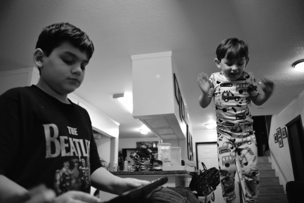 A black and white time-lapse sequence shows someone using a camera in multiple overlapping frames.