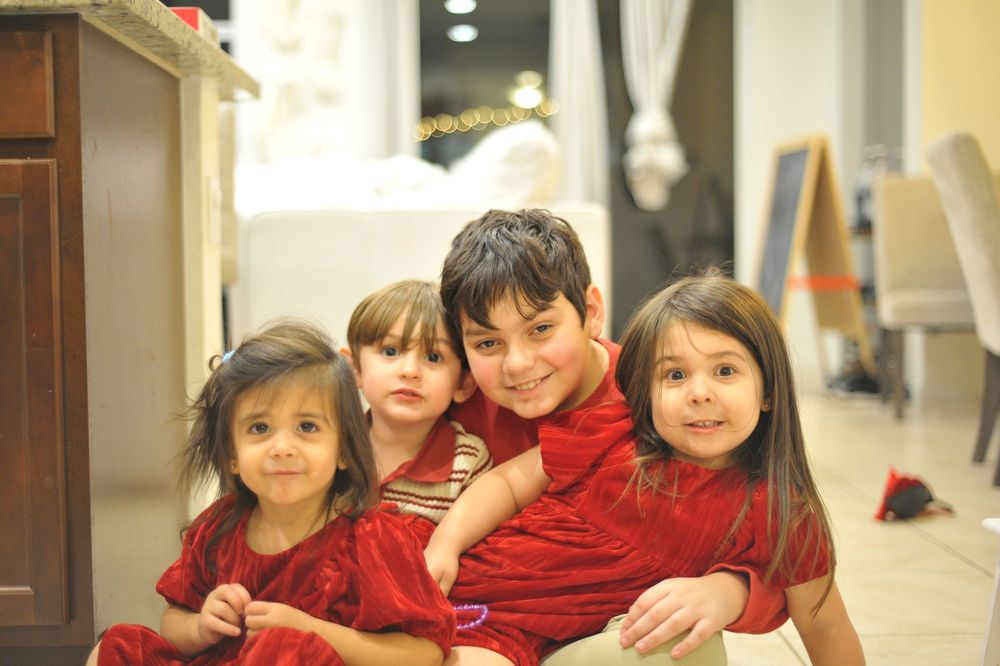 Students in red uniforms gather in a school hallway creating a playful and energetic learning environment.