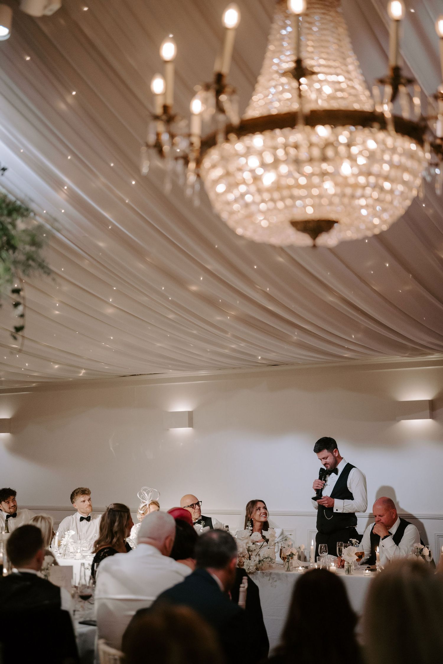 top table looking at the groom as he gives his speech at Iscoyd park
