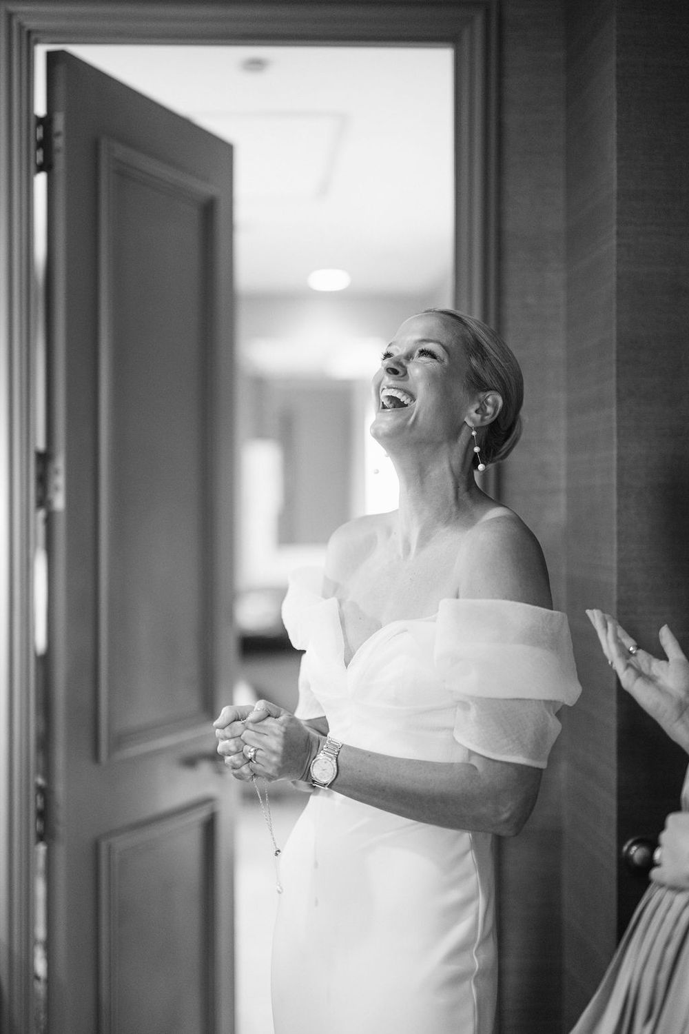 A series of black and white photographs showing joyful expressions in a hallway setting.