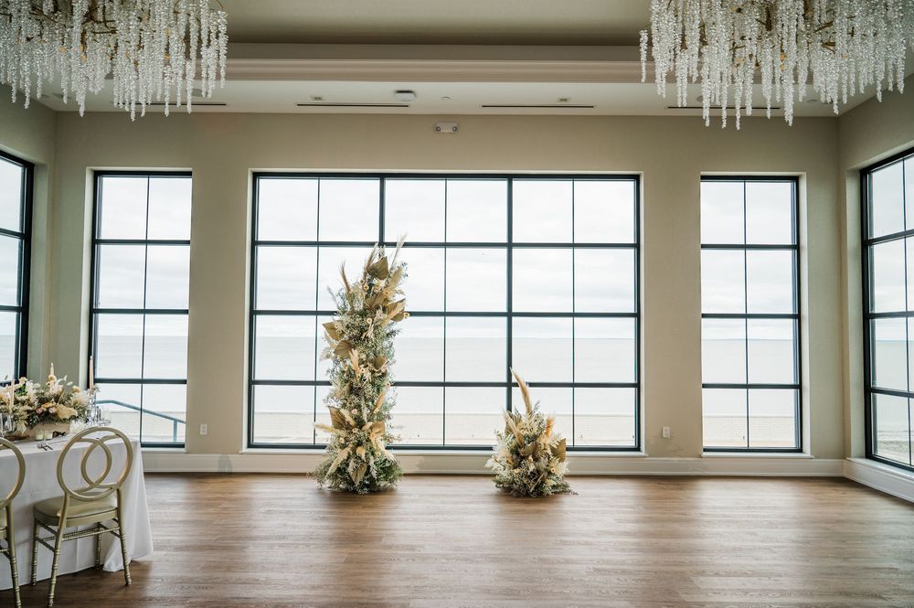 Modern event venue interior with crystal chandeliers and large windows providing natural light.