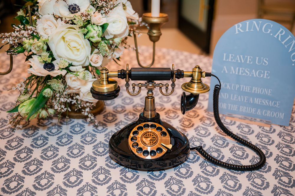 Wedding reception tables decorated with vintage-style candelabras, floral arrangements and patterned linens.
