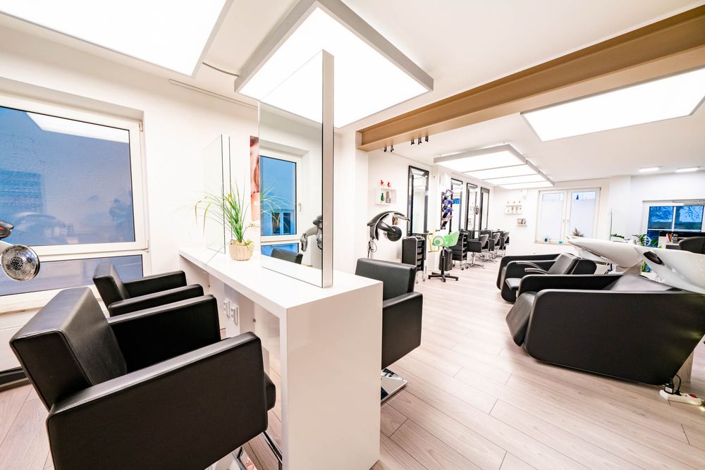 Modern white and black interior design of a luxury apartment with panoramic windows and sleek furniture.