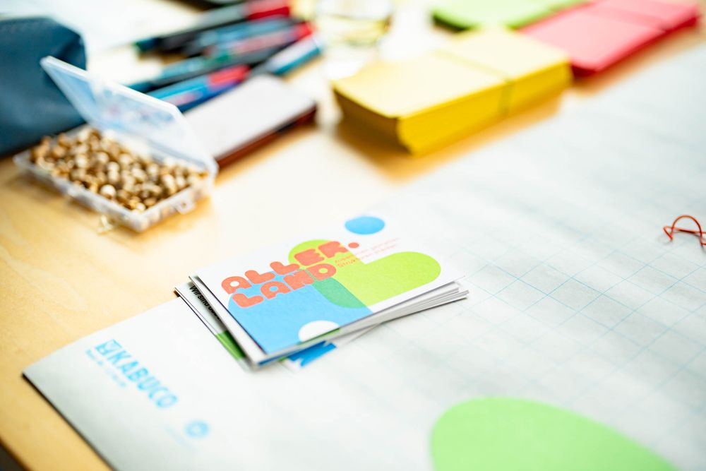Colorful office supplies and stationery items neatly arranged on a white desk surface.