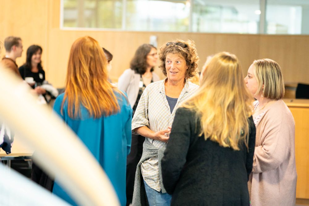 People gather in a bright indoor space with blurred motion creating a dynamic atmosphere during a social event.
