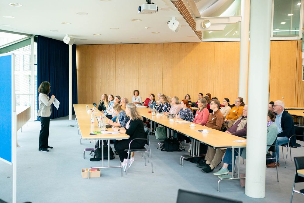 A panoramic view of students seated in rows during a classroom lecture presentation.
