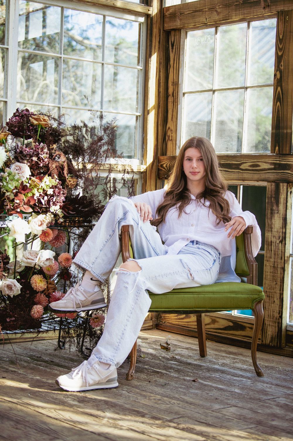 Dreamy sunlit greenhouse scene with floral arrangements and vintage furniture creating ethereal boho atmosphere.