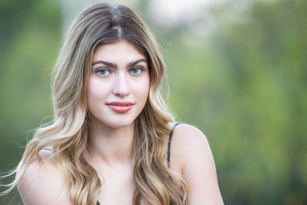 A series of portrait photos showing a young woman in varying expressions and poses outdoors with a blurred green background.